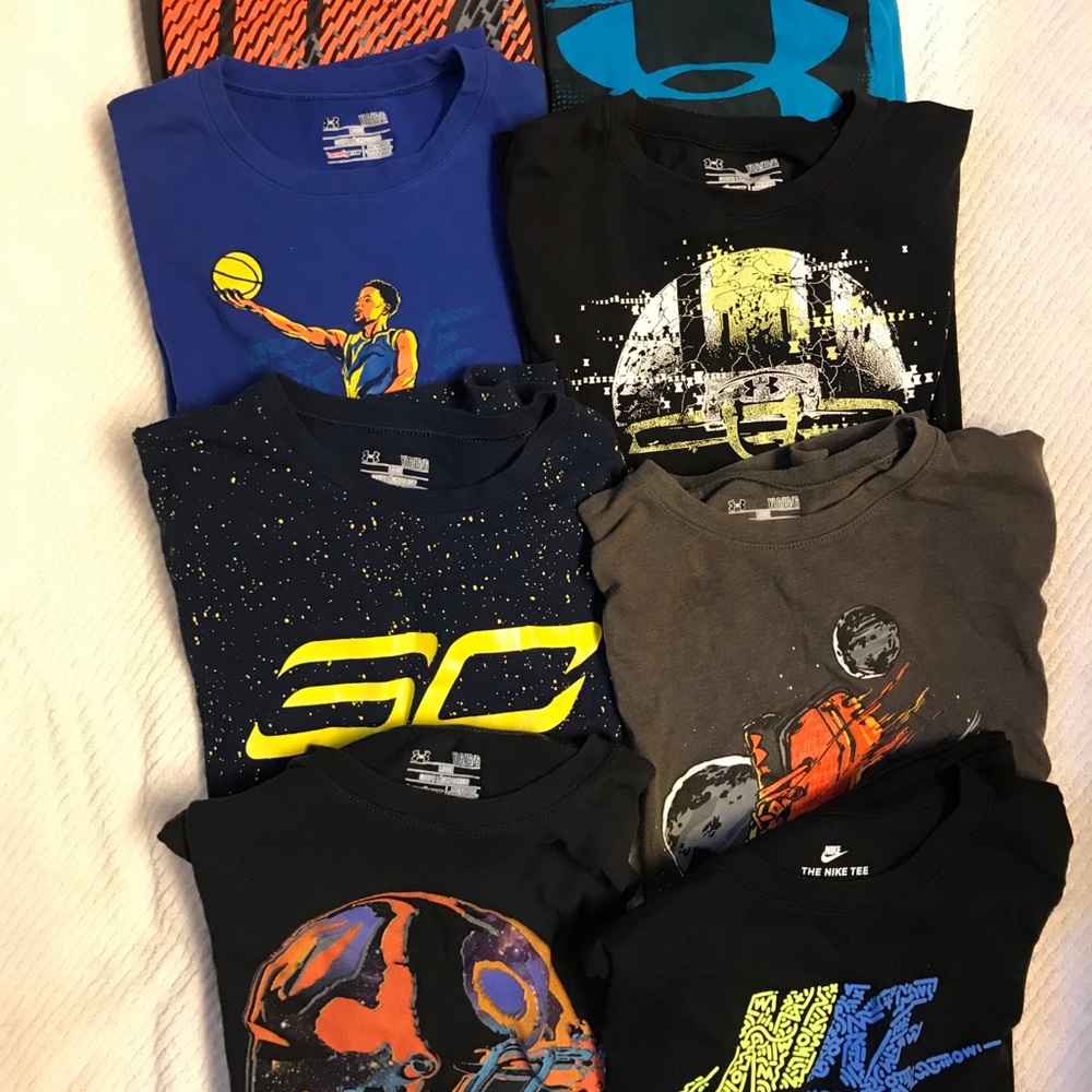Under Armor and Nike athletic shirts.  8 total.